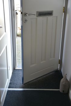 front door of house open with view on the street