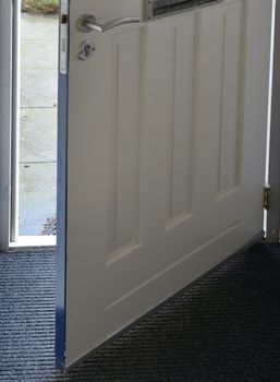 front door of house open with view on the street