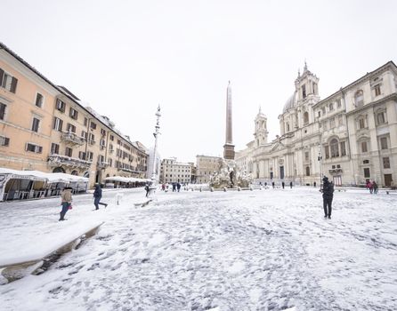 Rome, Italy, february 26th, 2018: Piazza Navona in Rome covered with snow with citizens and tourists walking in wonder after the unusual snowfall of February 26th 2018