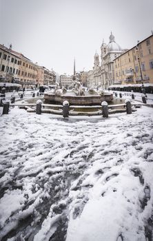 Rome, Italy, february 26th, 2018: Piazza Navona in Rome covered with snow with citizens and tourists walking in wonder after the unusual snowfall of February 26th 2018