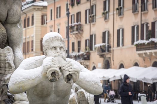 Rome, Italy, february 26th 2018: detail of the Fontana del Moro in Piazza Navona in Rome covered with snow after the unusual snowfall of February 26, 2018