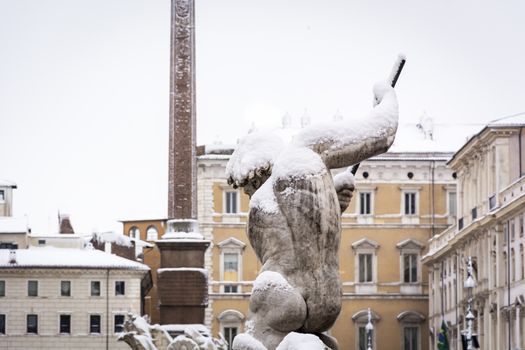 the statue of Neptune covered with snow after the unusual snowfall of February 26th 2018 in Rome, Italy