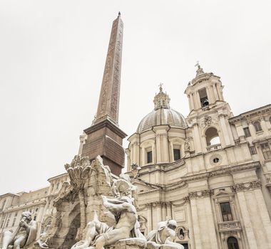 the fountain of the four rivers and the facade of the church of saint agnese in piazza Navona in Rome covered with snow after the unusual snowfall of February 26th 2018