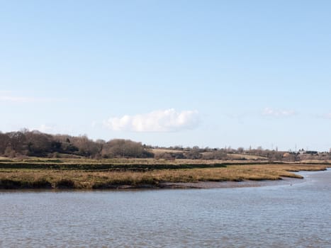 view of river stream in spring with horizon empty country; essex; england; uk
