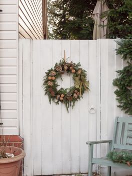 close up of winter wreathe door outside wooden white circle ornament decoration; essex; england; uk