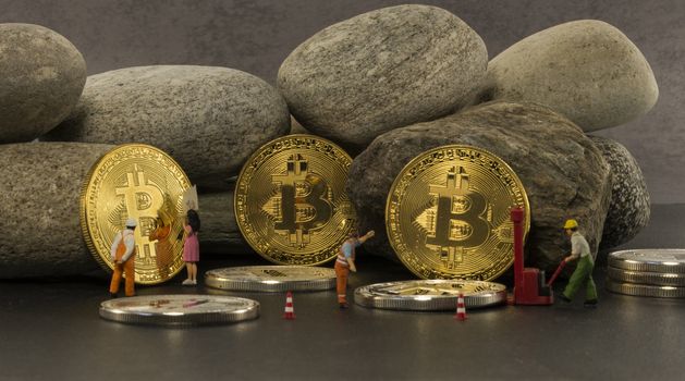little figures putting the bitcoins in a saf solid as a rock