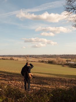 view of person looking out of large expanse space field agriculture nature landscape; essex; england; uk