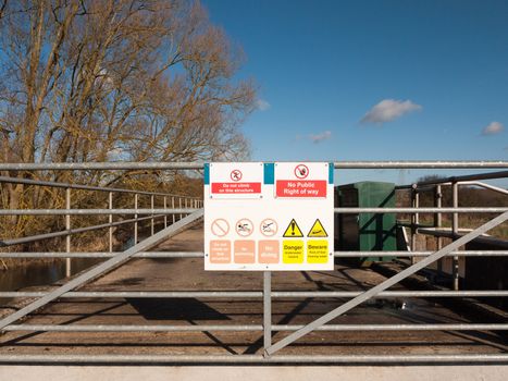 safety nature sign on locked metal gate do not climb this structure no public right of way warning; essex; england; uk