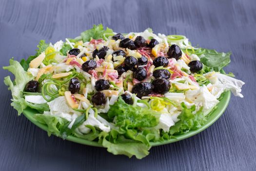 Green salad with vegetables, olives, cabbage, onions, sausages for healthy fitness slim diet