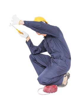 Electrician in unifrom with bunch of wires  invisible wall , isolated on white background cutout