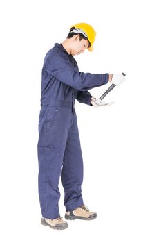 Young handyman in uniform standing with his hammer, Cutout isolated on white background