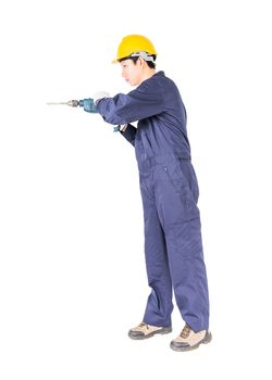 Young handyman in unifrom standing with his electric drill, Cutout isolated on white background