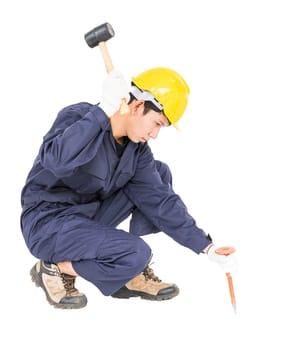 Young man in uniform sit and holding hammer was nailed to a cold chisel, Cut out isolated on white background