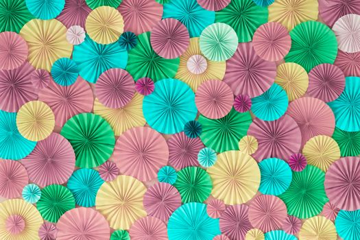 Colorful celebration background wall with multicolored paper circles of pink, lilac, yellow, green and blue colors