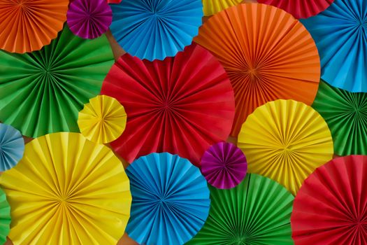 Colorful birthday celebration background wall with multicolored paper circles of red, yellow, blue, orange, green colors