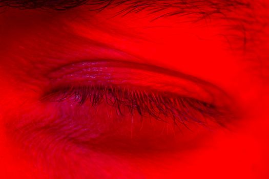 Macro close up on man with peaceful calm facial expression with close eyes. Portrait of meditating and thinking young man looking at camera.