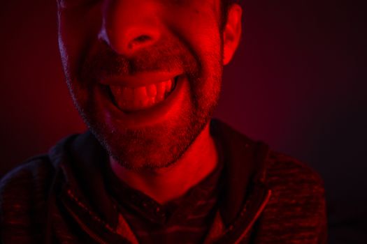 Man with happy smiling facial expression. Close up portrait of happy young man looking at camera.