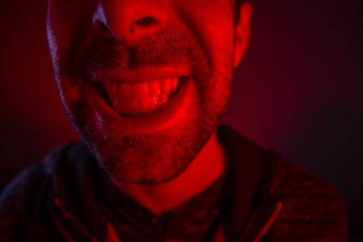 Man with happy smiling facial expression. Close up portrait of happy young man looking at camera.