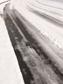 winter road through uk estate tracks no cars empty path snow; essex; england; uk