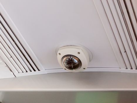close up of security cctv camera on train inside ceiling; essex; england; uk