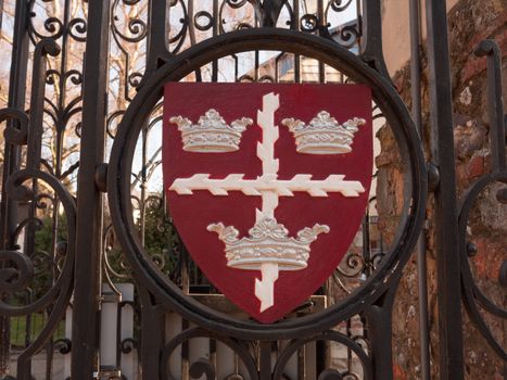 colchester shield sign emblem on gates red and black town park; essex; england; uk