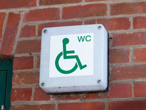 disabled wc toilet water closet sign outside on brick wall close up; essex; england; uk