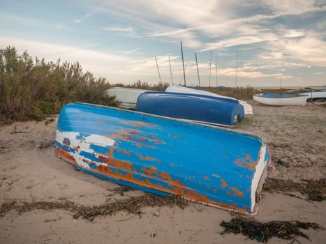 wooden beach boat shore coast upside down sand; essex; england; uk