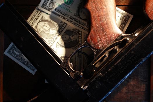 Old USA submachine gun closeup near one dollar bank notes