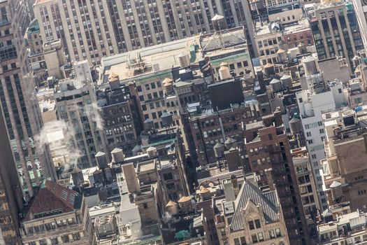 New York City, USA. Midtown Manhattan building rooftops with steam comming from the heating systems.