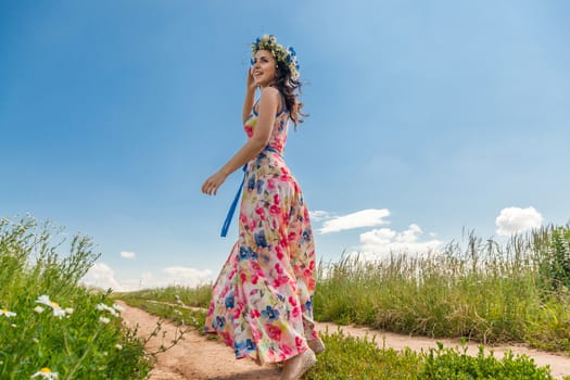 Portrait of the beautiful girl in the field to the utmost