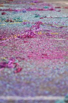 Close up view of Carnival confetti and paper ribbon on the ground.