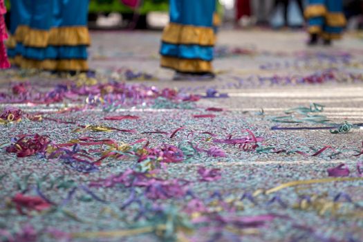 Close up view of Carnival confetti and paper ribbon on the ground.
