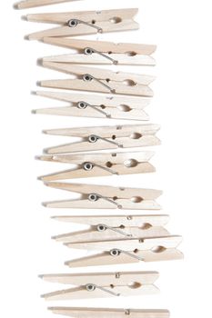 Aligned clothing pegs isolated on a white background.