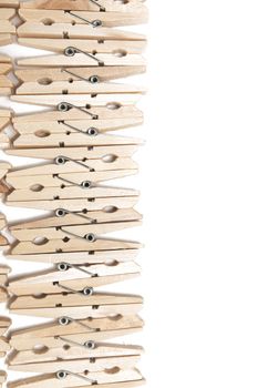 Aligned clothing pegs isolated on a white background.