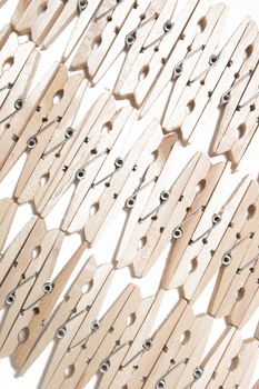 Aligned clothing pegs isolated on a white background.