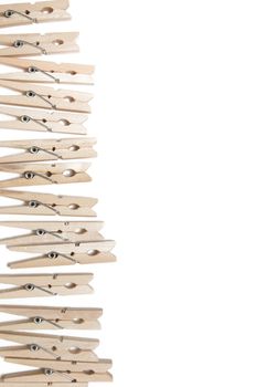 Aligned clothing pegs isolated on a white background.
