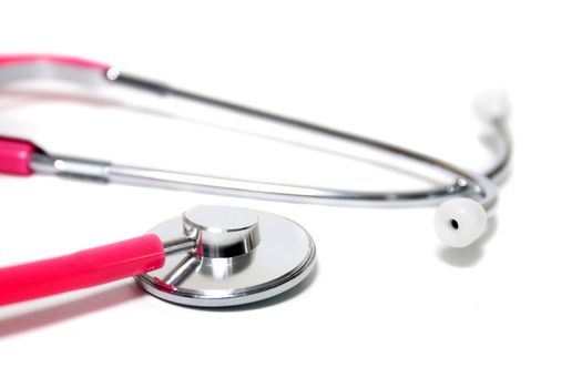 Close up view of a pink doctor's stethoscope isolated on a white background.