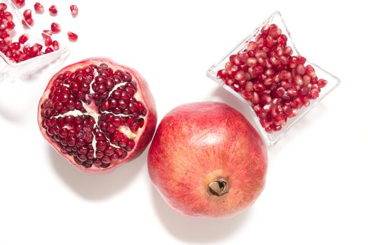 Close up view of tasty pommegranate fruit isolated on a white background.