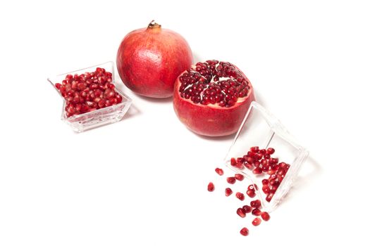 Close up view of tasty pommegranate fruit isolated on a white background.