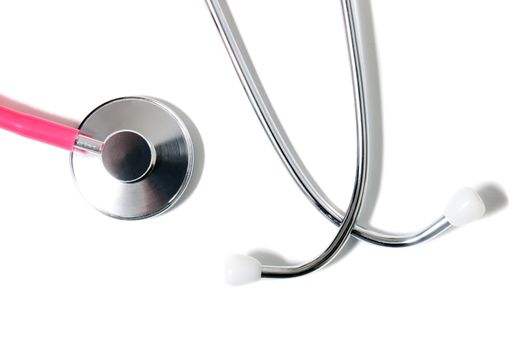 Close up view of a pink doctor's stethoscope isolated on a white background.