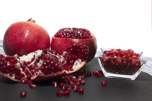 Close up view of tasty pommegranate fruit on top of a slate stone.