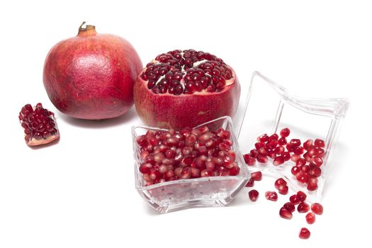 Close up view of tasty pommegranate fruit isolated on a white background.