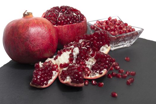 Close up view of tasty pommegranate fruit on top of a slate stone.