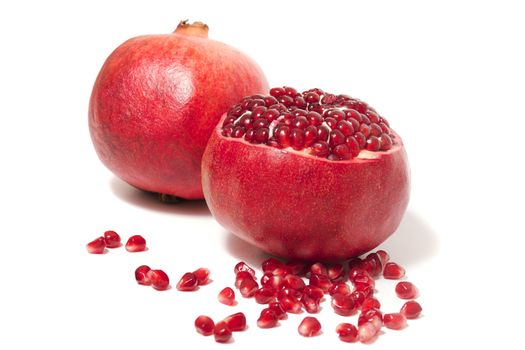 Close up view of tasty pommegranate fruit isolated on a white background.