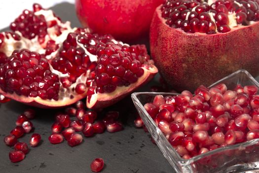 Close up view of tasty pommegranate fruit on top of a slate stone.