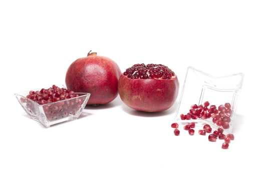 Close up view of tasty pommegranate fruit isolated on a white background.