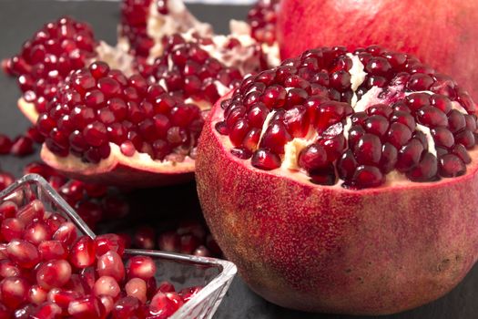 Close up view of tasty pommegranate fruit on top of a slate stone.