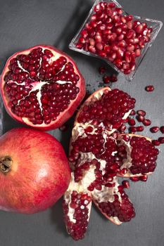 Close up view of tasty pommegranate fruit on top of a slate stone.