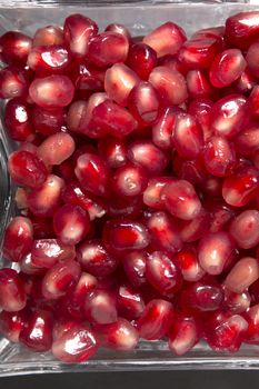 Close up view of tasty pommegranate fruit on top of a slate stone.