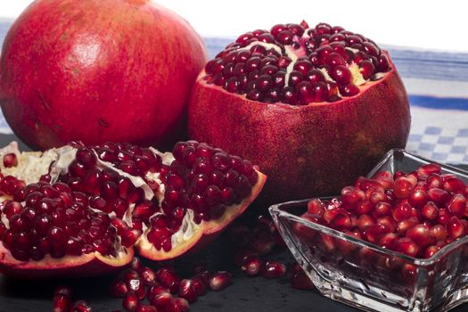 Close up view of tasty pommegranate fruit on top of a slate stone.